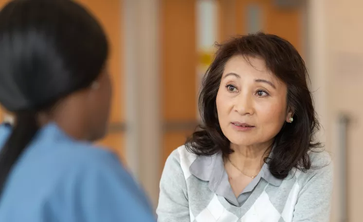 An Edward Jones financial advisor works with a client to educate her on how Edward Jones can help her prepare for the future.