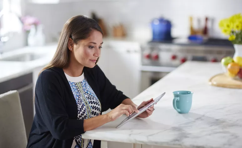 An Edward Jones client reviews financial documents on her tablet. An Edward Jones client reviews financial documents on her tablet.