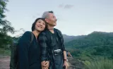 A man and women smiling and holding hands